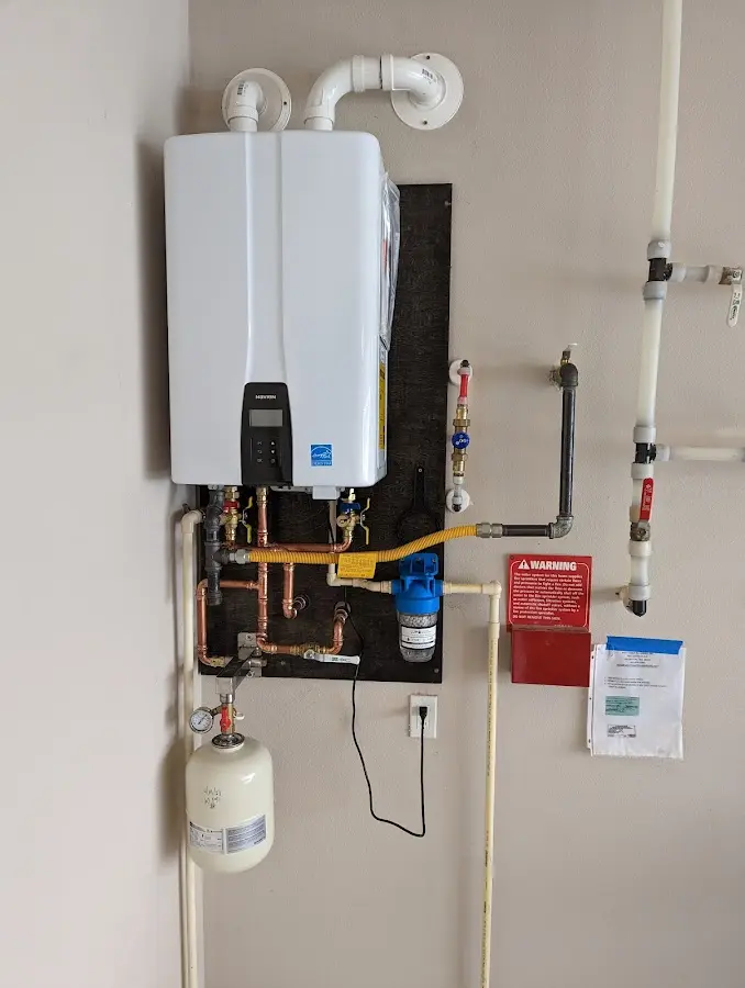 Professional plumber installing copper piping in a Dawson home